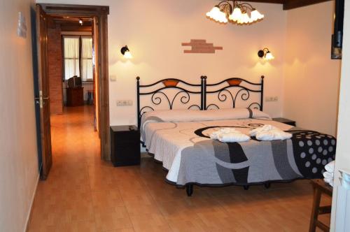a bedroom with a large bed and a hallway at Apartamentos Aguasaliu in Ponga