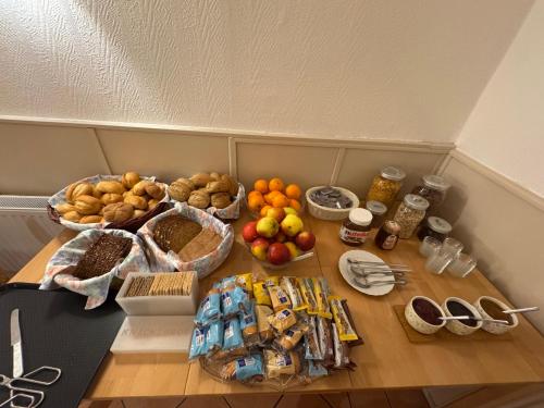 a table topped with baskets of fruit and other foods at Hotel Panorama in Wees