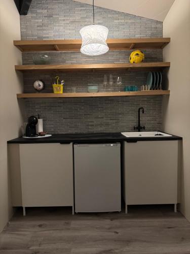 a kitchen with a sink and a counter top at The Rock Village Nook in Reykjavík