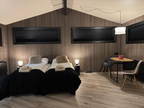 a bedroom with a bed and a table and chairs at The Rock Village Nook in Reykjavík