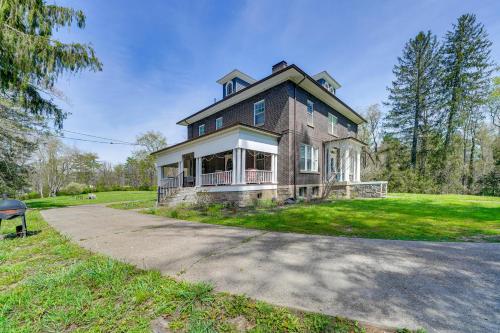 a large brick house with a porch and a driveway at 9 Mi to New River Gorge Spacious Retreat with Porch in Glen Jean