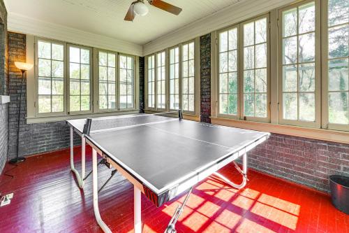 a ping pong table in a room with windows at 9 Mi to New River Gorge Spacious Retreat with Porch in Glen Jean