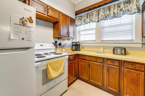 a kitchen with white appliances and wooden cabinets at 9 Mi to New River Gorge Spacious Retreat with Porch in Glen Jean