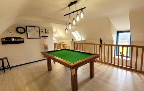 a pool table in the middle of a room at Ti Glas in Grand-Champ