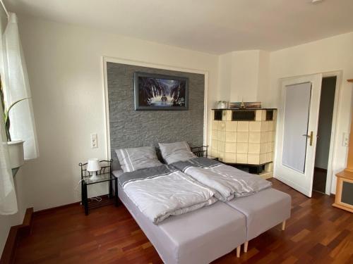 a bedroom with a large bed with white sheets at Gästezimmer Limburg City in Limburg an der Lahn