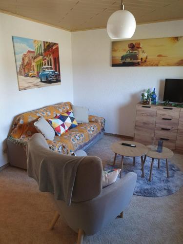 a living room with a couch and a table at Wünschel Stube in Gossersweiler-Stein