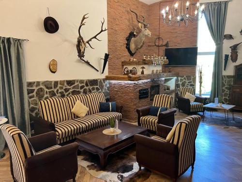 a living room with couches and a fireplace at Wellness Apartmán Monika - Tatranská Štrba in Štrba