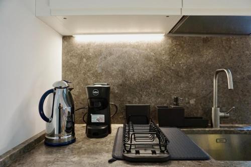 a kitchen counter with a coffee maker and a blender at Villa Pola Liberty house Mondello in Palermo