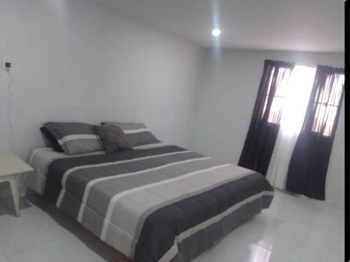 Ένα ή περισσότερα κρεβάτια σε δωμάτιο στο Casa cómoda con todo