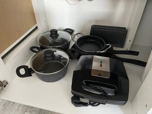 a stove top with pots and pans on a counter at Relax21 in Uherský Ostroh