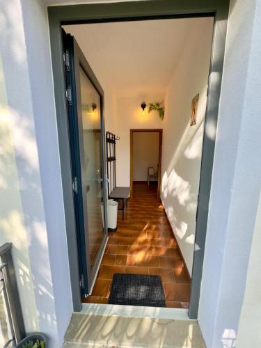 a hallway of a house with a door open at Casita in Radda in Chianti