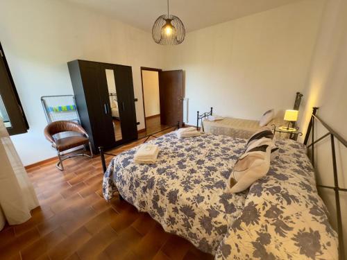 a bedroom with a bed and a chair at Casita in Radda in Chianti