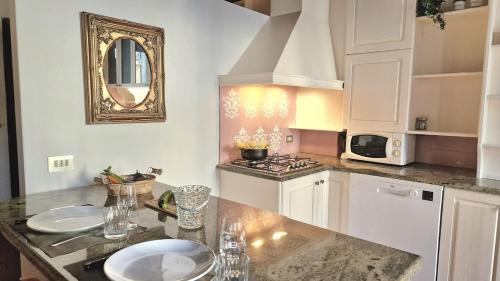 a kitchen with white cabinets and a counter top at Ca'Dinora - Venetia apartment - in Bardolino