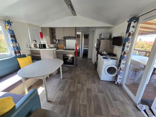 une cuisine et un salon d'une caravane dans l'établissement Grands mobil-homes 4 chambres clim-parking privées-possibilité d'accueil jusqu'à 20 voyageurs-Siblu, à Gastes
