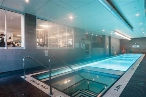 a large indoor swimming pool with a large swimming poolvisor at Downtown Toronto Condo Suite in Toronto