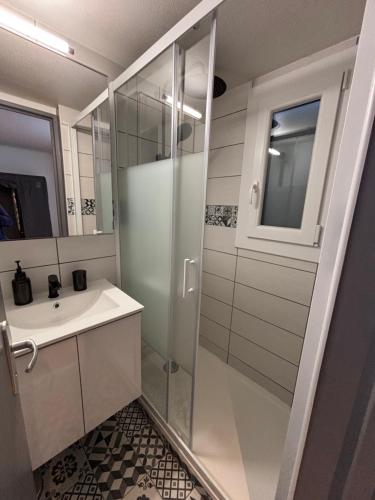 une salle de bain avec douche et lavabo dans l'établissement Maison grande terrasse vue mer - Plage et GR34 à 400m, à Guidel