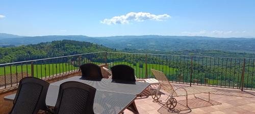 a table and chairs on a balcony with a view at La Terrazza sull'Umbria in Collazzone