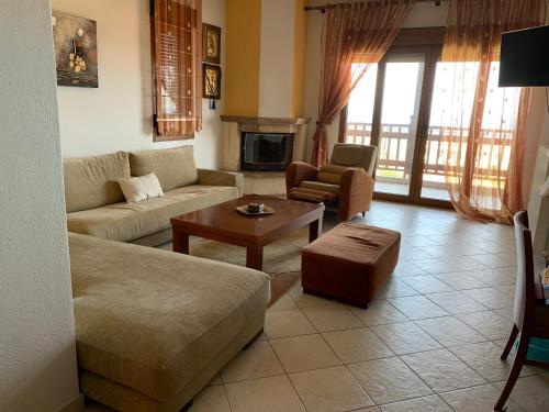 a living room with a couch and a table at Sweet Home Nea Roda! in Nea Roda