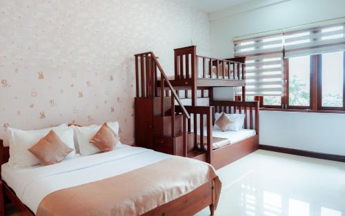 a bedroom with two beds and a spiral staircase at Royal Retreat ,Kandy in Kandy
