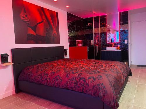 a bedroom with a bed with a red bedspread at Cap sur le Paradis in Cap d'Agde