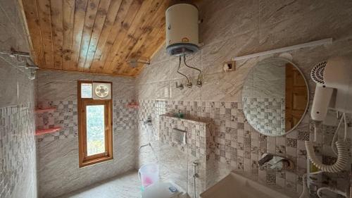 a bathroom with a sink and a mirror at Kaushalya Homes in Shimla