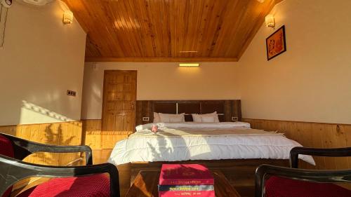 a bedroom with a bed with a wooden ceiling at Kaushalya Homes in Shimla