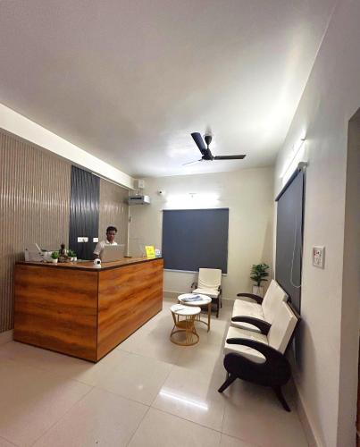 a man sitting at a reception desk in a room at Hotel Crystal INN in Bhubaneshwar