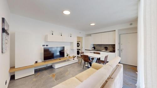 a living room with a white couch and a table at Il Rifugio sul Fiume in Cassano dʼAdda