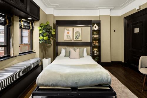 a bedroom with a large bed and a chair at Heart of NY, Steps away from all Attractions in New York
