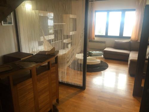 a living room with a desk and a couch at Cozy 150m2 Apartment , 2 Parking places in Belgrade