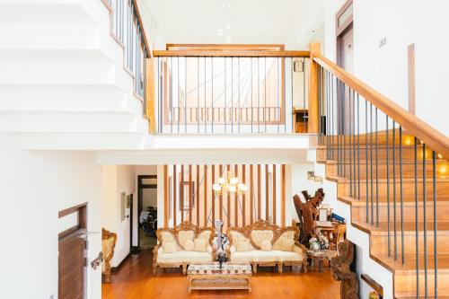 a living room with a couch and a staircase at Royal Retreat ,Kandy in Kandy