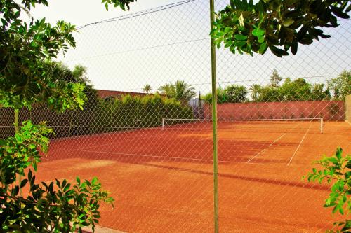 a tennis court with a net on a tennis court at Dar Sabra in Marrakech