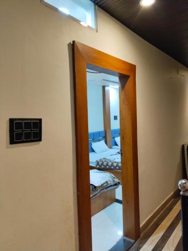 a mirror in a room with two beds at Hotel Shreem in Ujjain