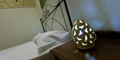 a pair of shoes sitting on top of a bed at Masseria Bosco Mazza in Melendugno