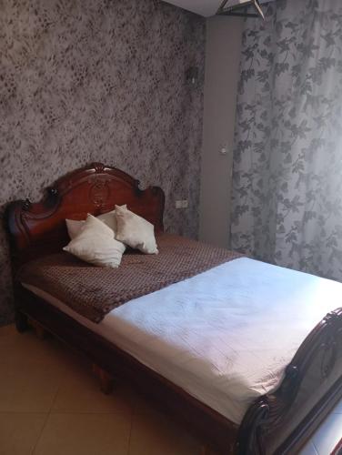 a bed with two pillows on it in a bedroom at Elegant apartment in Rabat in Rabat