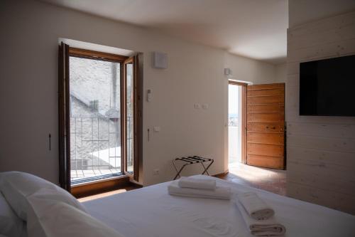 a bedroom with a bed and a large window at Vicolo Effe in Terracina