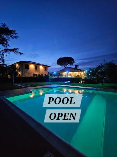 a swimming pool is lit up at night at Airone Pisa Hotel Ristorante in Pisa