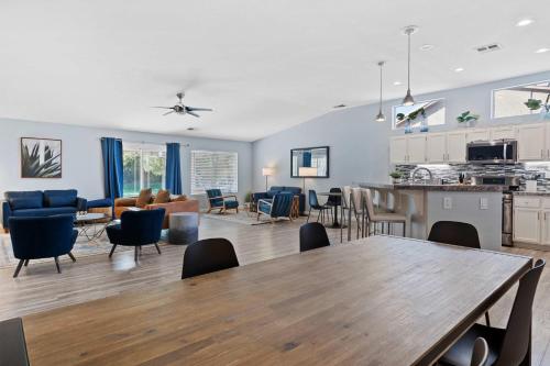 a kitchen and living room with a table and chairs at Antigua Villa - Volleyball - Pool - 5Bd in Indio