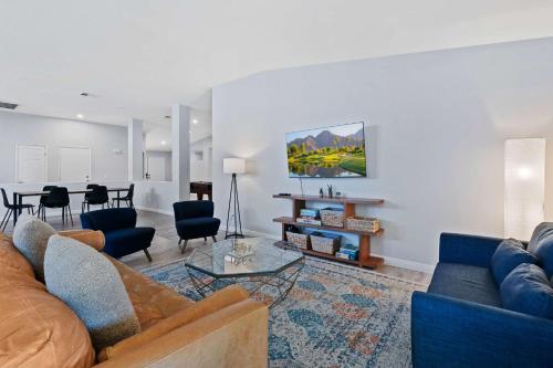 a living room with a couch and a table at Antigua Villa - Volleyball - Pool - 5Bd in Indio