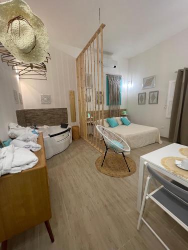 a room with a bedroom with two beds and a table at Molly's Home Otranto in Otranto