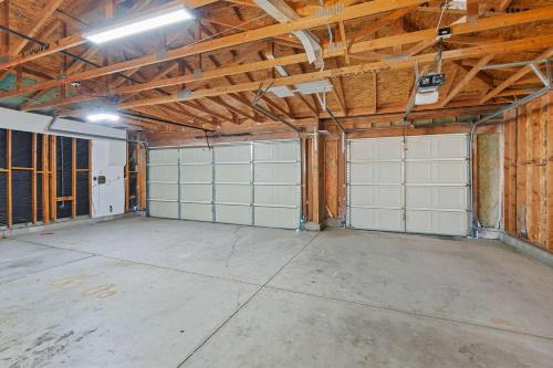 an empty garage with two white garage doors at Antigua Villa - Volleyball - Pool - 5Bd in Indio