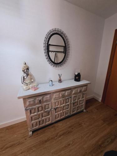 a bathroom with a vanity with a mirror on the wall at Apto Vistas al Mar -Punta del Cavall in Salou