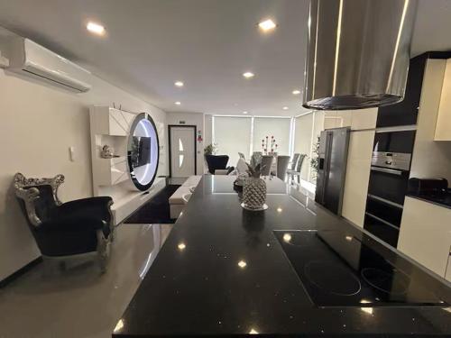 a large living room with a table and a living room at Home S&F- Ponte de Vagos in Ponte de Vagos