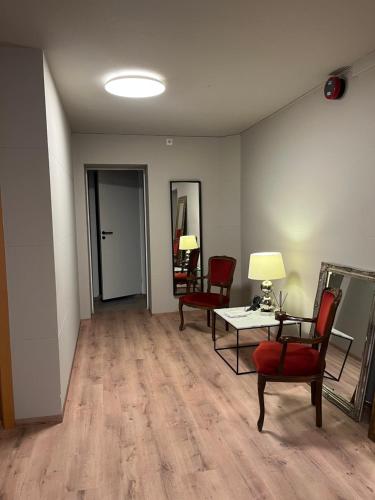 an empty room with two chairs and a table and a table sidx sidx at Guesthouse Hvammur by the Harbour in Höfn