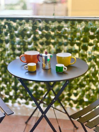 three coffee cups on a table on a balcony at GioGio house in Vico Equense