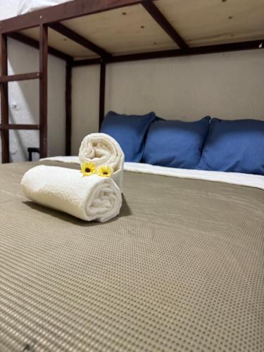 a towel sitting on the floor of a bed at Pousada Cores do Pelô in Salvador