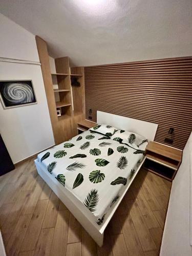 a bedroom with a large bed with a white comforter at Apartmani Kim in Starigrad