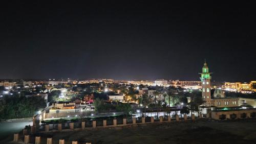 a city skyline at night with a clock tower at Hurghada Village sea view in Hurghada