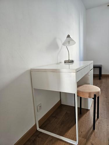a white desk with a lamp and a stool at Spacieux T3 avec vue sur le Palais des Papes in Avignon