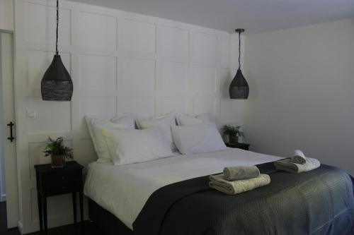 a bedroom with a bed with two towels on it at Fig Tree Cottage 1 x Super King or 2 x Single Beds in Busserolles